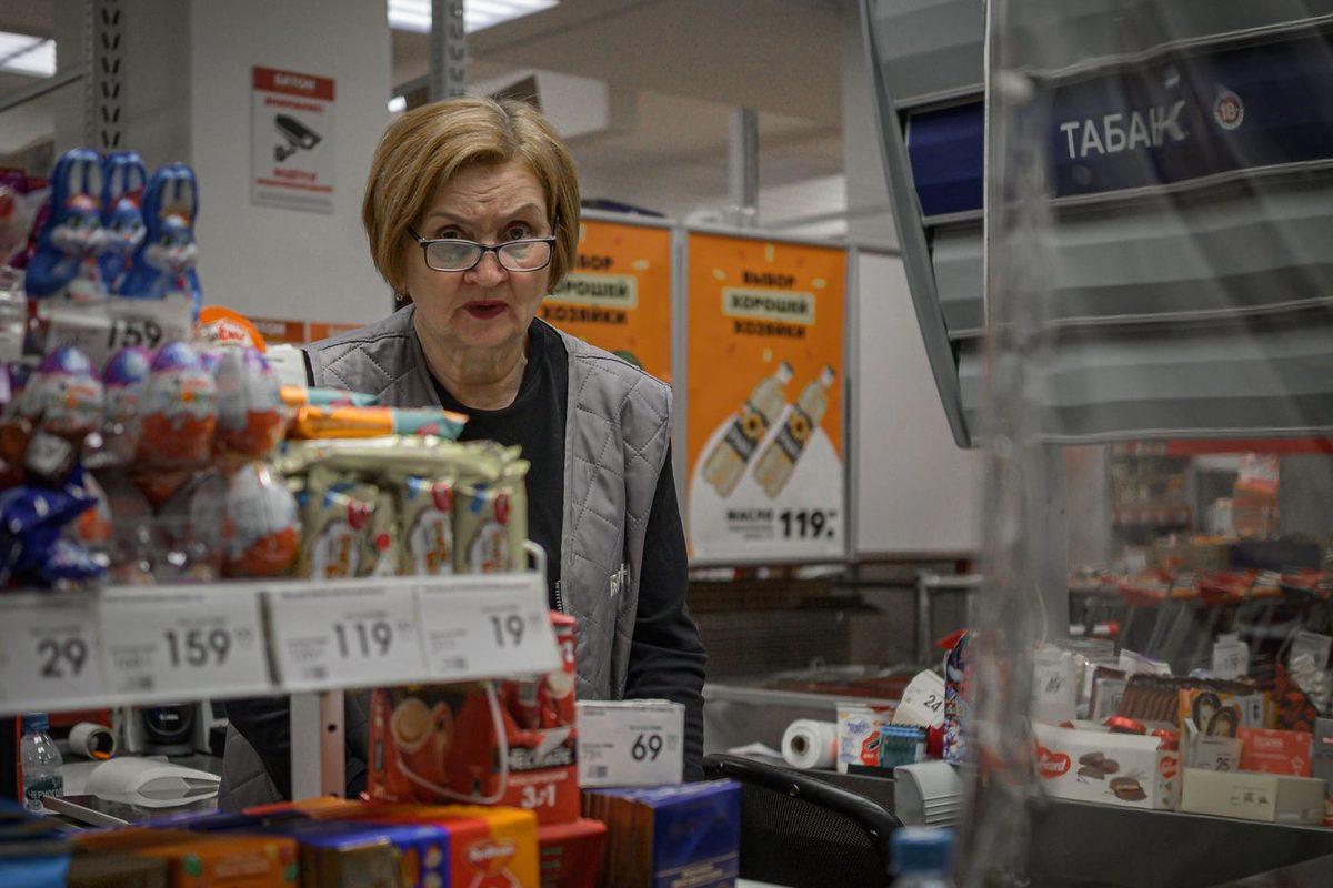 A cashier at a supermarket checkout